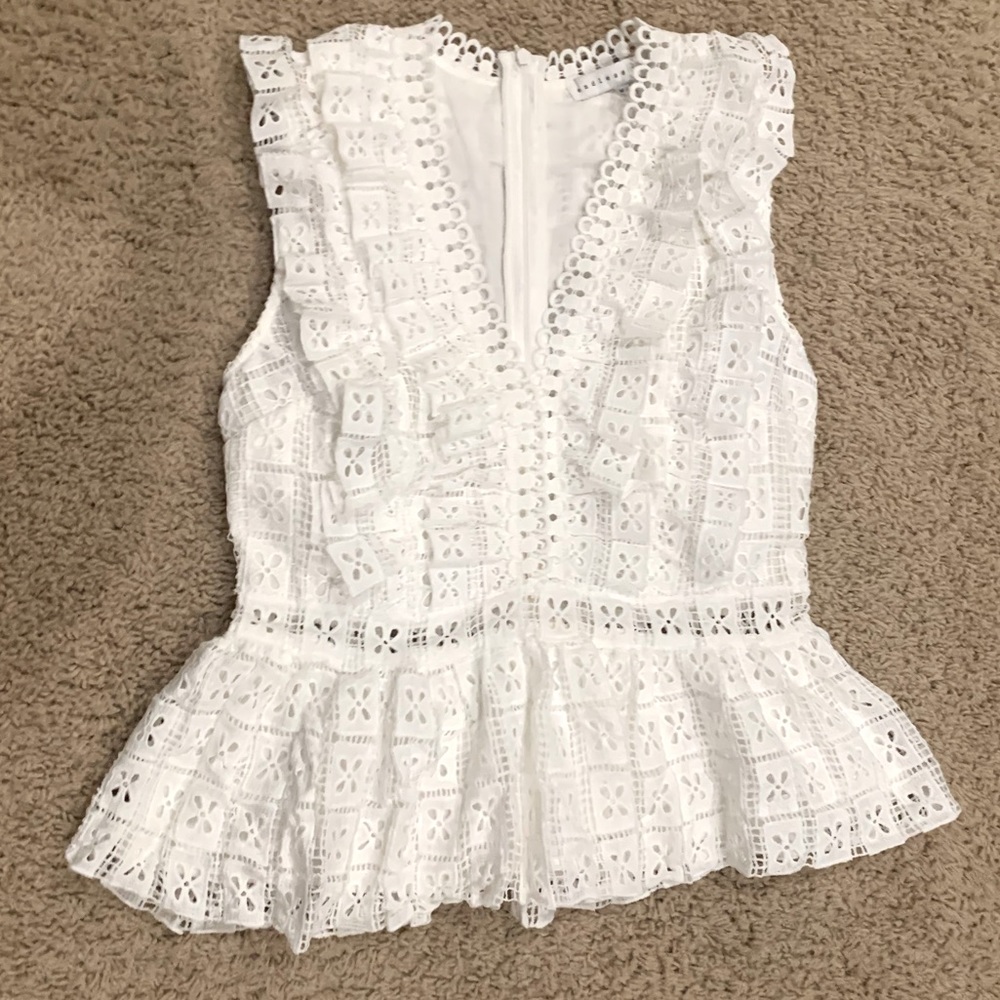 Beautiful white peplum style eyelet top- sleeveless. Never worn with tags.